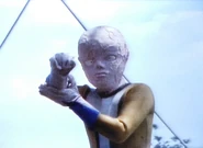 Alien Virenus putting his bracelet in his hand