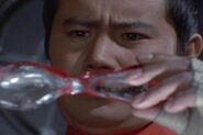Dan Moroboshi holding his damaged Ultra Eye in Ultraman Leo.
