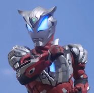 Ultraman Geed Solid Burning wielding the Geed Slugger