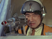 Arashi felt guilty for causing Hayata and the children serious injuries due to his impulsiveness. He then went alone with the QX gun in the Jet VTOL to confront Zaragas.