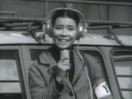 Sakurai as a YY TV Reporter in Kaiju Booska