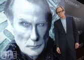 Bill Nighy in front of a large poster of himself as Viktor.