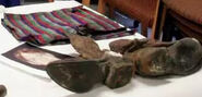 Sketch, swim trunks, and boots of the victim.