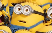 A short and plump two eye Minion with buzz cut hair.