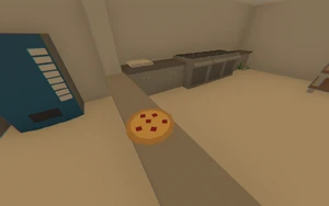 A newly crafted Pizza inside a Pizza Shop.