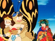 Ataru, dressed as Mothra, embracing a girl dressed as Wonder Woman.