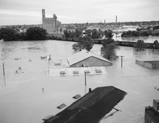 A photo taken from I-95 showing several submerged buildings after Hurricane Agnes.  As shown in this photo, many Richmond businesses and industries were located in the James River's floodplain