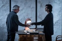 Rashid giving Daniel Claudia's diaries