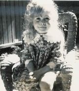 Michele posing in her wicker chair