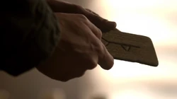 Rune for "Child" in Kaleb's hands