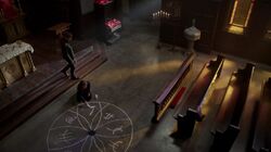 Davina draws a seal on the Church's floor