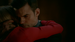 Elijah hugs Rebekah, after telling the family his plan