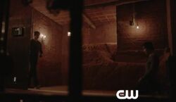 Jeremy bringing vampire blood for Damon to control his urges.