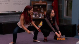 Cat and Jade squatting on stage