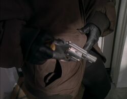A close-up of Sharon's friend's gun during her heel turn