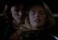 Jennifer holding Amy at knifepoint