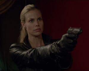 Suzanne holding Michael at gunpoint