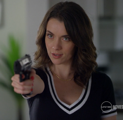 Phoebe holding a gun threatening Melanie and her mother