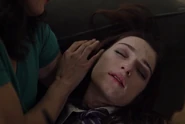 A deceased Claire/Elena in Rebeca's arms