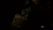 A close-up of Angela's gun being pointed at Megan Hunt as part of Angela's on-screen heel turn