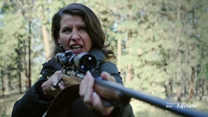 Natasha holding Catherine at gunpoint