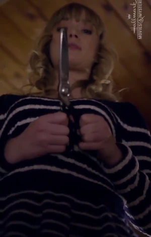 Cara clutching the scissors during her reveal