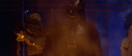 Vader stops Boba Fett from firing his blaster at a rampaging Chewbacca.