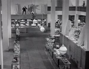 Grover trying in vain to catch Wacky swinging on some lamps