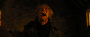 Silva screaming in agonizing pain after having a combat knife hurled into his back, fatally wounding him.