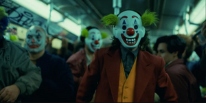 Joker wearing a mask to blend in with the Clowns.