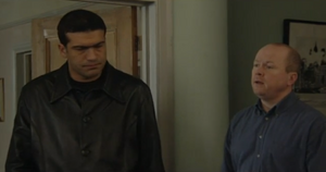 Phil Mitchell summons Stringer's henchman to collaborate on his plan against Dan.