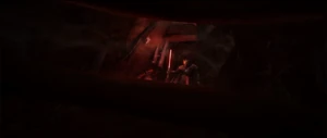 Savage using his lightsaber as a light underground.
