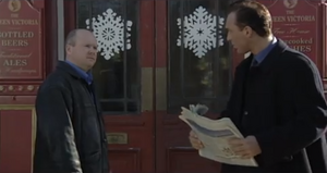 Phil glances hatefully at Steve outside the square (2000).