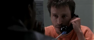 Korda shocked when Scott shows him a photograph of Teal's corpse.