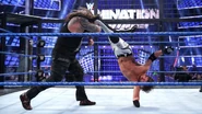 Styles kicking Bray Wyatt in the Elimination Chamber match.