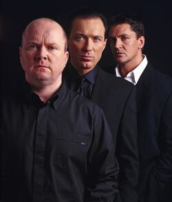 Dan Sullivan in the background with his arch-nemesis Phil Mitchell and fellow enemy Steve Owen respectively.