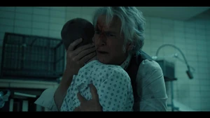 Brenner saddened over Ten's death as he cradles his body.