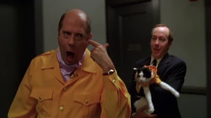 Garfield-movie-screencaps.com-979.jpg (175 KB) Chapman wheezing as he leaves the set, with Wendell holding Persnikitty following him.