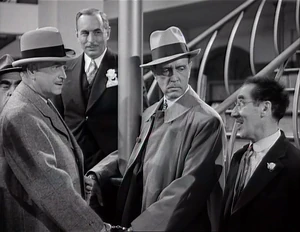 Grover grinning over Flywheel's incompetence when the "killers" turn out to be the Hastings brothers: George and Arthur