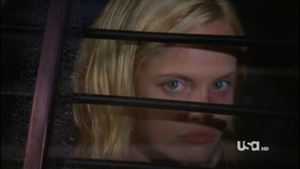 Allsion glaring at Shawn and Gus as she driven to jail.