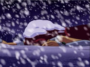 Having lost it and wandered to far into the storm Starfire faints to the freezing temperatures