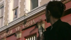 Stella notices that Ben is watching her from The Queen Vic window.