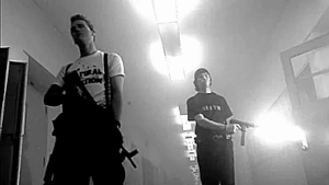 Eric and Dylan in the hallway, the latter shooting into a classroom.