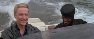 May Day driving a speedboat alongside her boss Max Zorin