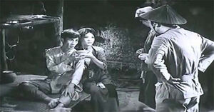 The Gaoler threatening Mr. Dậu to pay tax.