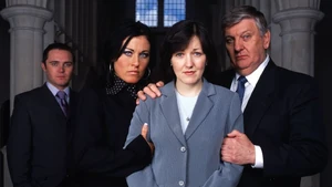 Trevor Morgan watches as Kat and Charlie comfort Little Mo in the background of her trial promo.
