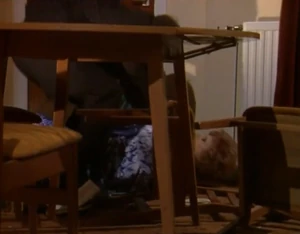 Alan throttling Rita from the ground.