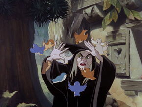 Queen Grimhilde getting attacked by the birds.