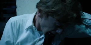 The orderly biting down on his belt as Eleven removes the Soteria chip in his neck.