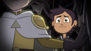 Hunter and Luz standing in front of a grave of every Golden Guard.